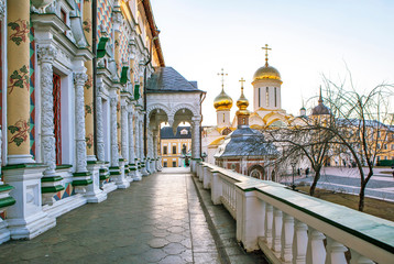 Carved columns and a large “autumnal” porch of the refectory overlooking the Trinity Cathedral and the Mikheevsky Church. Trinity Lavra of St. Sergius. Sergiev Posad. Russia