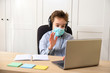 © wip-studio - schoolboy in medical mask studying at home. Distance learning online education, coronavirus quarantine