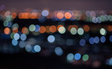 Fototapeta Miasto - The circle Bokeh lights, city view at night, colourful, black background taken with lens blur
