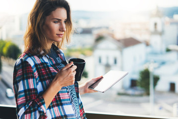 Wall Mural - Hipster girl using tablet technology and drink coffee, social distance concept, girl person holding computer on background sun city, online wifi  internet technology