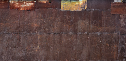 Iron rusty sheets. A metal wall with clinging paint texture