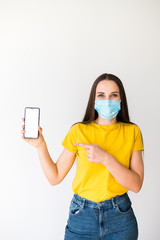 Wall Mural - Woman in medical mask shows her phone screen