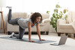 © Prostock-studio - Fit Young Woman Excersising At Home, Watching Video Tutorial On Laptop