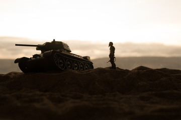 War Concept. Military silhouettes fighting scene on war fog sky background, World War Soldiers Silhouette Below Cloudy Skyline At sunset.