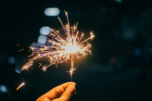 Close-up Of Person Holding Sparkler At Night