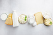 Fresh dairy products, milk, cottage cheese, eggs, yogurt, sour cream and butter on white table, top view
