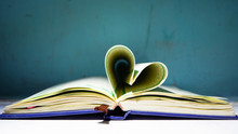 Close-up Of Heart Shape Pages Of Book On Table