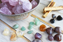 A Top View Image Of Rose Quartz And Various Energy Healing Crystals On A White Wooden Table. 