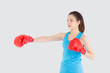 © NT_studio - Beautiful portrait young asian woman wearing red boxing gloves with strength and strength isolated on white background, girl workout exercise is sport training with punch, health concept.