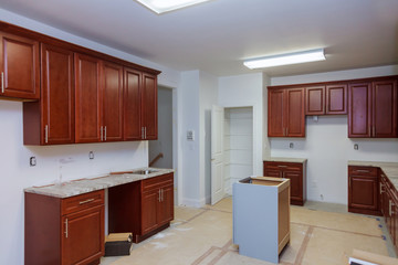 Wall Mural - Installing cabinets and counter top a kitchen partially installed furniture.