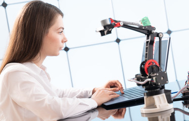 Canvas Print - Woman student with robot model arm