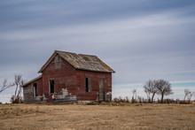 An Abandoned Red Brick Farmhouse In A Farmyard Near Coderre, Saskatchewan
