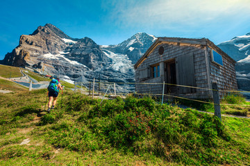 Sporty hiker woman walking on the hills, Grindelwald, Switzerland