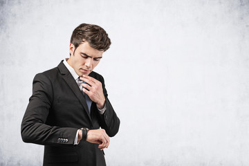 Wall Mural - Thoughtful businessman looking at watch, mock up