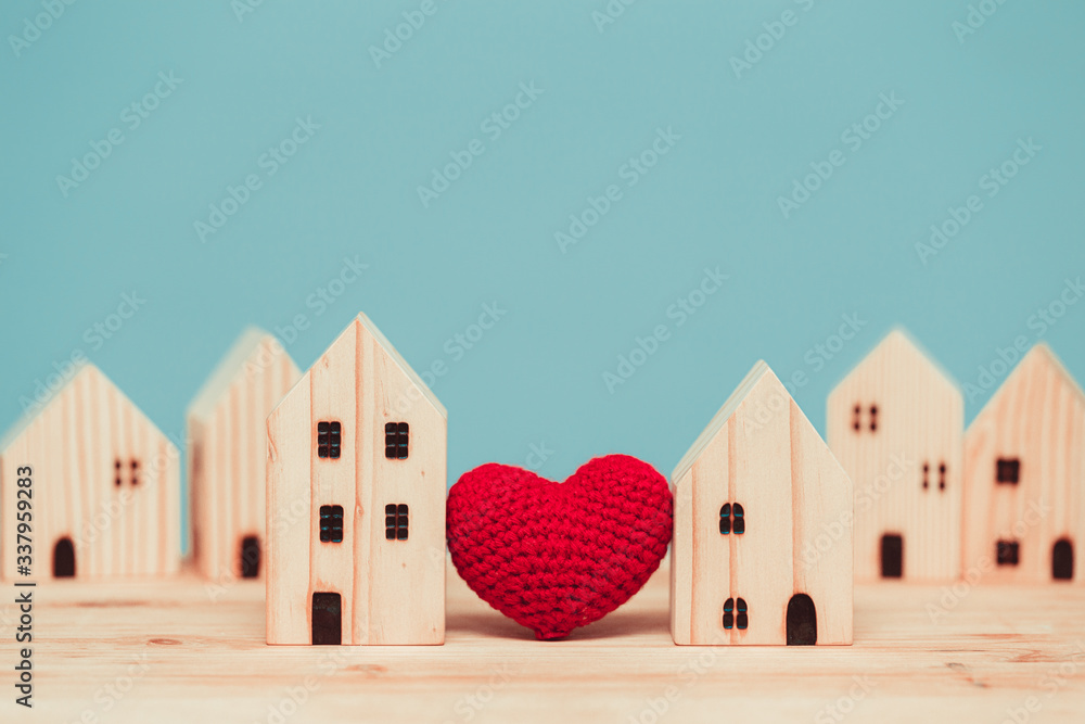 Love heart between two house wood model for stay at home for healthy community together concept. - obrazy, fototapety, plakaty 