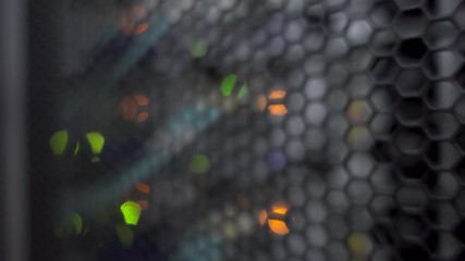 Wall Mural - honeycomb pattern doors inside modern big data server rack in the data center. blurred background.