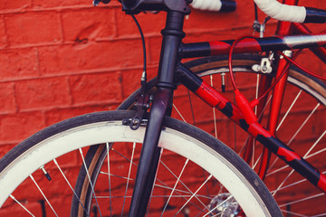 urban bicycle against red bricks wall in city