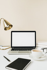 Wall Mural - Blank screen laptop. Home office desk table workspace with coffee, lamp, glasses, notebook on beige background. Copy space mockup blog, website template. Blogger, outsourcing freelancer hero header.