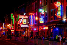 Crowd In Illuminated City At Night
