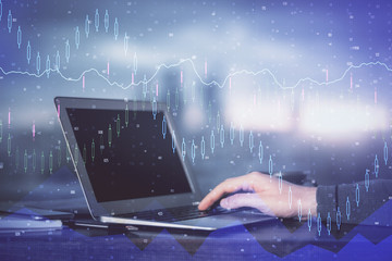 Double exposure of stock market graph with man working on laptop on background. Concept of financial analysis.