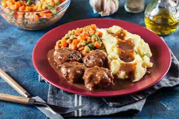 Wall Mural - Roasted meatballs in dark sauce with mashed potatoes