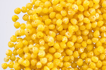 millet round yellow seeds on a white background