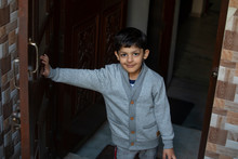 Young Boy Opening The Door. (Children) 
