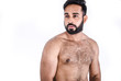 Handsome young male Asian athlete posing shirtless on white background