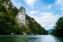 The Face Of The Dacian King Decebal. Panoramic View Of The Danube River. 