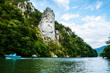 The face of the Dacian king Decebal. Panoramic view of the Danube river. 