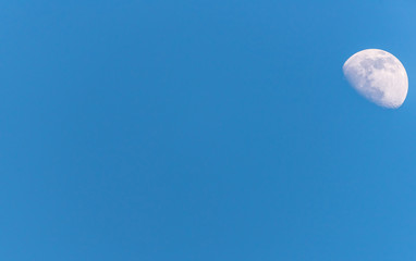 Wall Mural - Three Quarter Moon in a Blue Sky