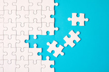Many White Jigsaw Puzzle On Blue Background - Idea Solution Concept.