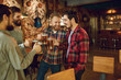 © Studio Romantic - Group of happy friends clinking glasses with beer at a sports bar.