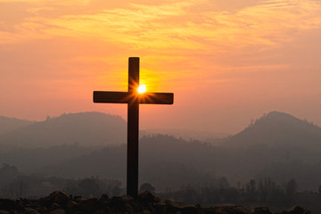 Silhouette cross on mountain at sunset background.Crucifixion Of Jesus Christ