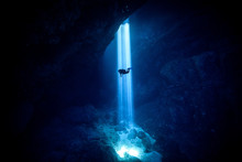 Sunlight Falling On Silhouette Person Scuba Diving Undersea