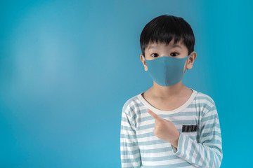 boy in medical face protection mask on blue background