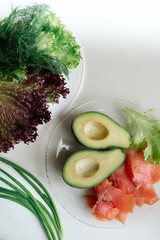 Wall Mural - Avocado with red fish and lettuce - healthy breakfast	