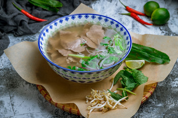 Wall Mural - Soup Pho Bo with beef on grey table. Vietnamese cuisine.