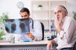 © Elnur - Young male doctor and old patient in antismoking concept