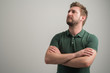© Cipri Suciu  - Portrait of serious stylish attractive man with thick beard, dressed in casual green t shirt standing with arms crossed