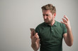 © Cipri Suciu  - Portrait of serious stylish attractive man with thick beard, dressed in casual green t shirt using mobile applications texting on cellphone