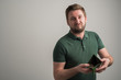 © Cipri Suciu  - Portrait of serious stylish attractive man with thick beard, dressed in casual green t shirt showing empty wallet