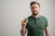 © Cipri Suciu  - Portrait of serious stylish attractive man with thick beard, dressed in casual green t shirt hold the glass of wine
