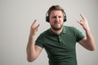 © Cipri Suciu  - Portrait of serious stylish attractive man with thick beard, dressed in casual green t shirt listening rock music