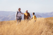 © Mediteraneo - Three generations of family hiking together in the autumn.