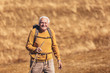 © Mediteraneo - Senior man on hike through beautiful countryside in autumn.