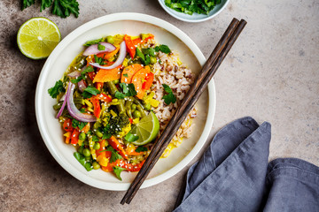 Canvas Print - Vegan curry with broccoli, pepper, green beans and brown rice in a bowl, top view.