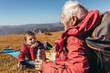© Mediteraneo - Boy camping with grandfather in autumn.