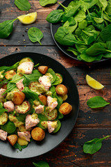 Wall Mural - Salmon, new potato, courgette and spinach salad on wooden table