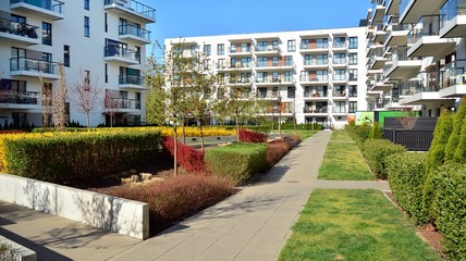 Contemporary residential building exterior in the daylight. Modern apartment buildings on a sunny day with a blue sky. Facade of a modern apartment building